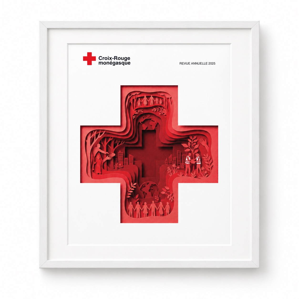 Couverture de la revue annuelle 2025 de la Croix-Rouge monégasque, présentée dans un cadre blanc avec passe-partout blanc.