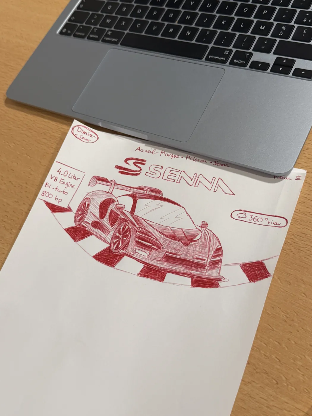 Dessin étudiant d’une McLaren Senna au stylo BIC rouge sur une feuille posée près d’un ordinateur.